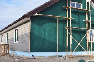 Building house with wall insulation waterpfoof membrane plastic siding